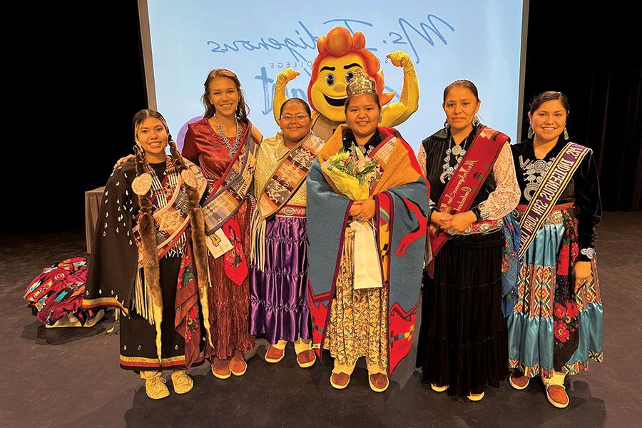 Ms. Indigenous SJC 22-23 Jaymie Begay, Lynell Pablo, Ms. Indigenous SJC 2023-24 Dalilah Tsosie, Tia Harvey, Rhianna Carel, Gabriella Mason and SJC Mascot Blaze.